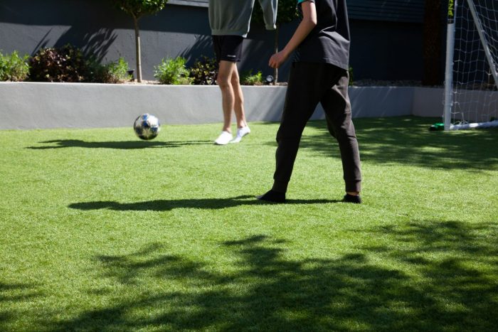 Kicking a football on artifical grass